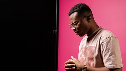 Young man against pink background