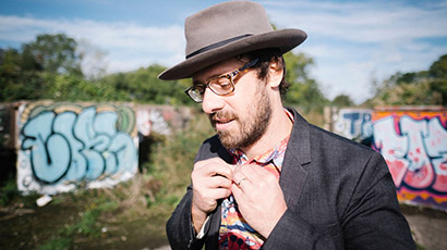 Photo of Geoff Widdowson standing in front of graffiti. Photo of Geoff Widdowson standing in front of graffiti.