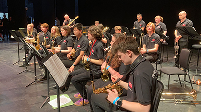 Seated band ensemble on stage