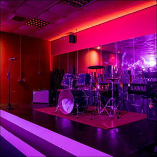 Musical equipment set up on an empty stage.