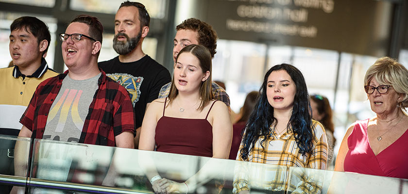 The Technicolour choir performing in public.