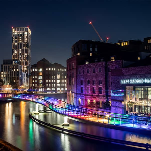 Bristol harbourside lit up at night.