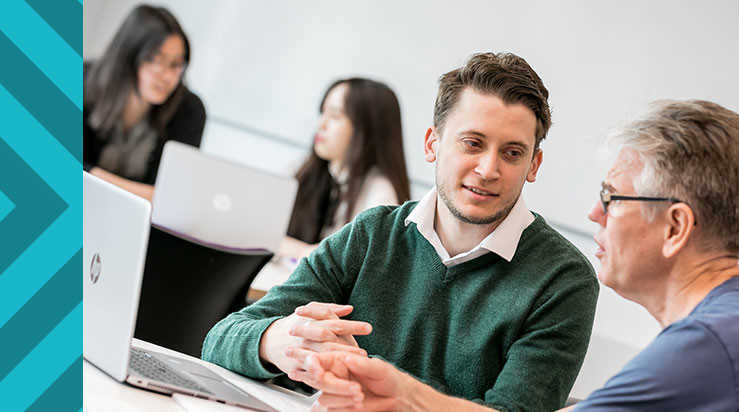 Two students talking in a study environment