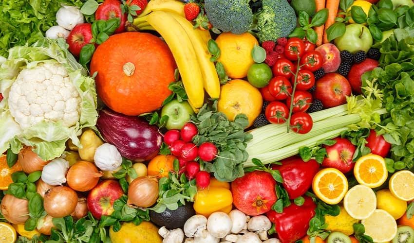 A mixture of colourful fruit and vegetables displayed on a table.