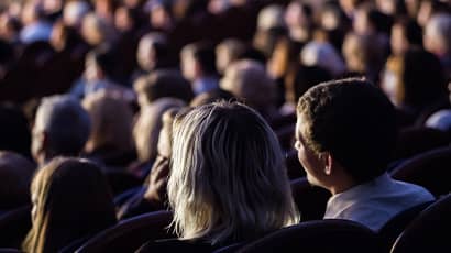 An audience watches a film in a cinema.