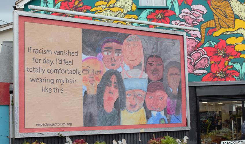 A billboard in St Werbughs in Bristol shows children's illustrations and the words if racism vanished for day I'd wear my hair like this