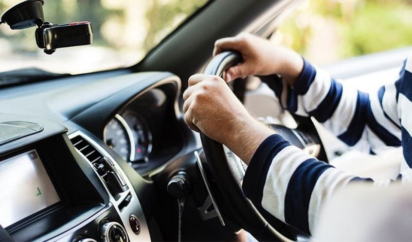 hands on the steering wheel of a car