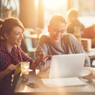 Two students looking at a laptop