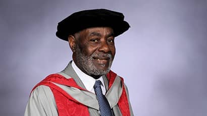 Guy Bailey dressed in cap and and gown.