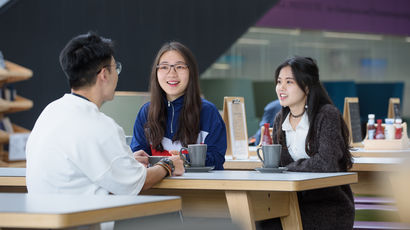 International students sit at a table together