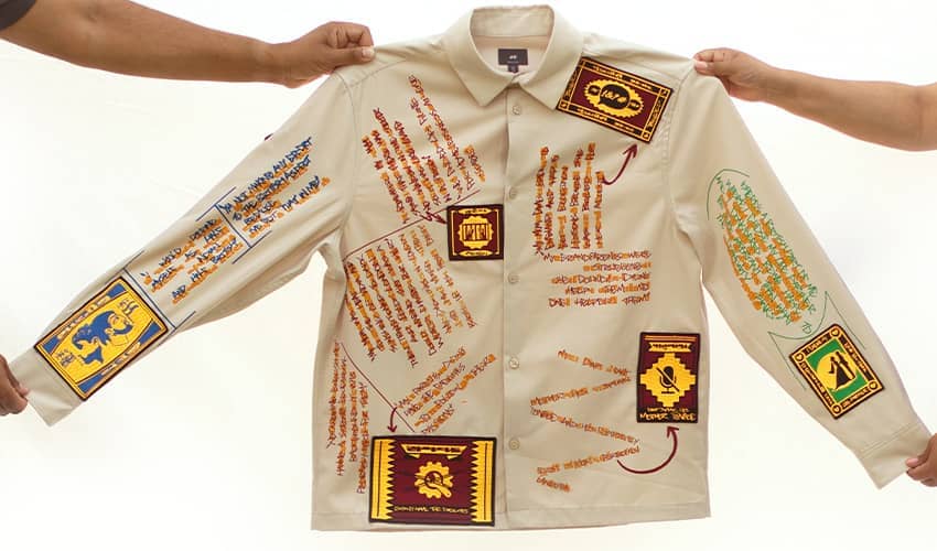 A beige coloured shirt features quotes stitched onto the fabric which blend Bollywood-inspired Gujarati dialect and graffiti-style English
