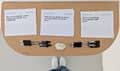 Overhead view of a table with printed question cards about creative labour, pens, and handwritten response space.