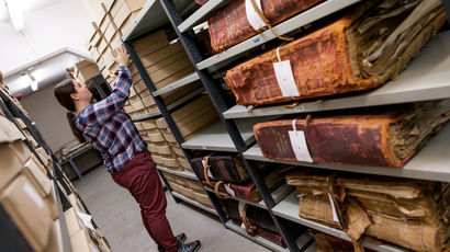 Student with old manuscripts