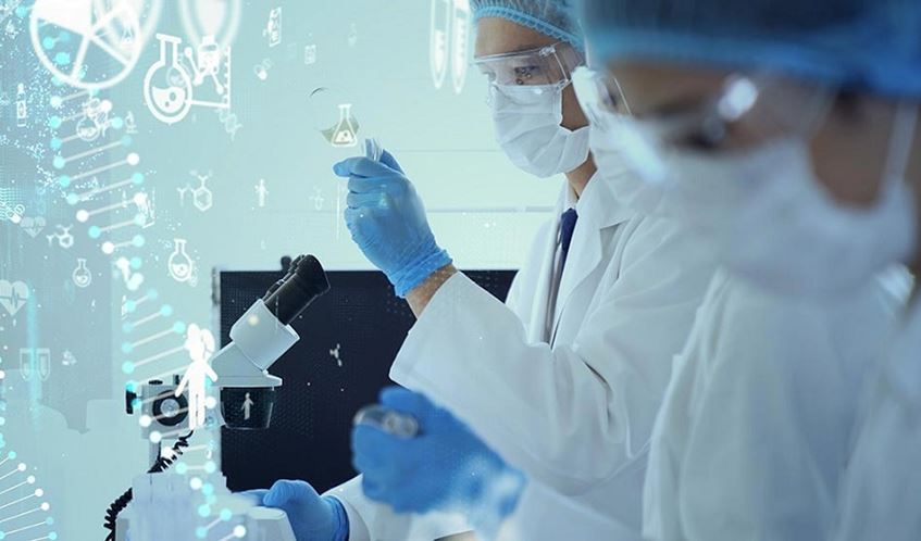 Two researchers using a microscope in a lab