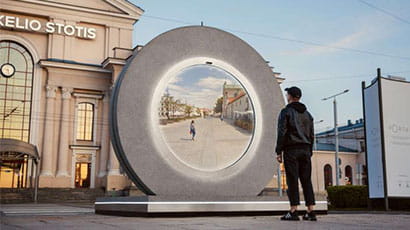 Man standing in front of round screen Portal in Vilnius