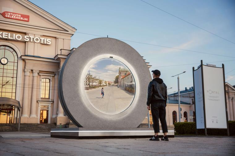 Man standing in front of round screen Portal in Vilnius