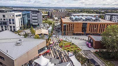 Aerial view of a university campus, showing buildings and people