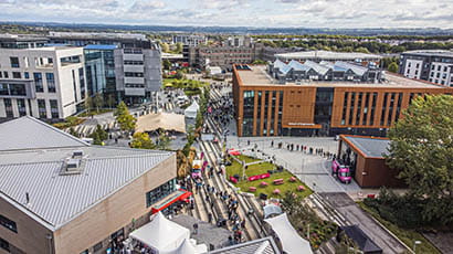 Aerial view of a university campus, showing buildings and people