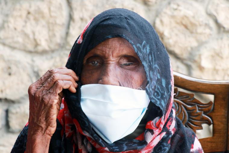 A photo of an older Somali woman wearing a mask over the lower half of her face