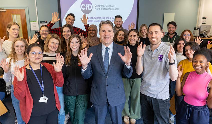 Dan Norris posing for a photo with a large group