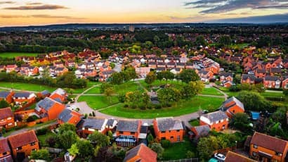 A new build housing estate with a circle of greenery in the centre