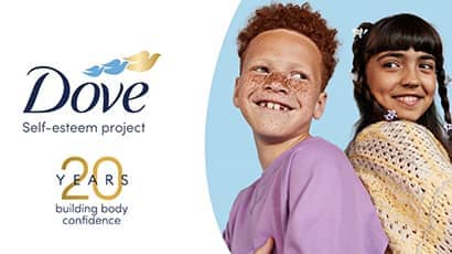 A graphic which shows the Dove logo alongsisde a smiling boy in a purple top back to back next to a smiling girl in a beige knitwear