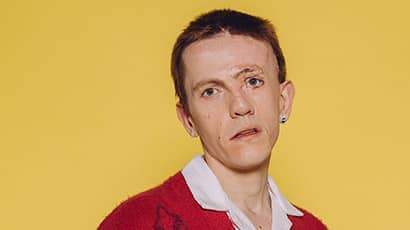 Actor Robert Rhodes looking at the camera, with a yellow background