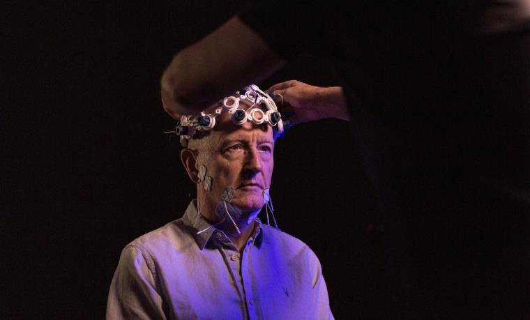 An image of artwork of man wearing medical probes on head and face.
