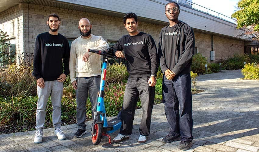 Employees of technology startup Nearhuman Amin Alhawary, Ali Ekbal, Faizan Mir and Yerim Mohamed stood with a rental e-scooter outside a university building