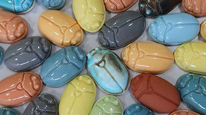 Multicoloured selection of pottery pieces that look like computer mice.