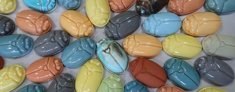 Multicoloured selection of pottery pieces that look like computer mice.