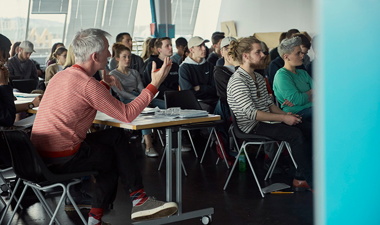 A large group of people sitting in a classroom.