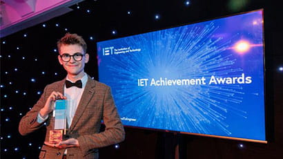 Jared Newnham holding his Institute of Engineering and Technology apprentice winner award