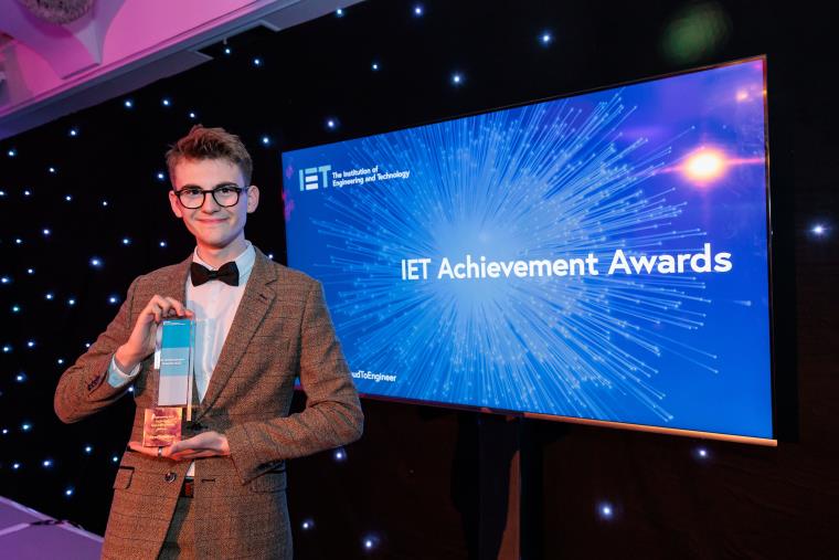 Jared Newnham holding his Institute of Engineering and Technology apprentice winner award