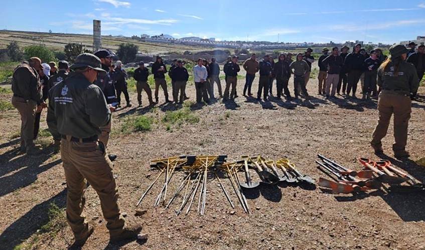 A image of people searching for graves in Mexico, with spades and other tools on the ground