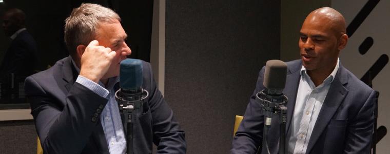 Professor Steve West and Marvin Rees talking in a recording booth.