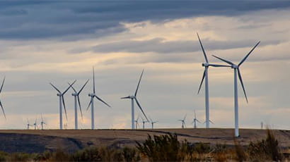 Wind turbines on a countryside hill.