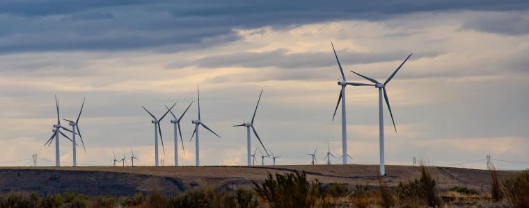 Wind turbines on a countryside hill.