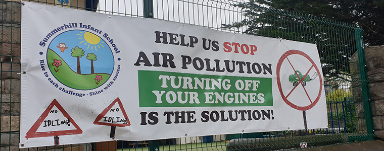 A banner telling people to turn off their engines around schools to stop air pollution.
