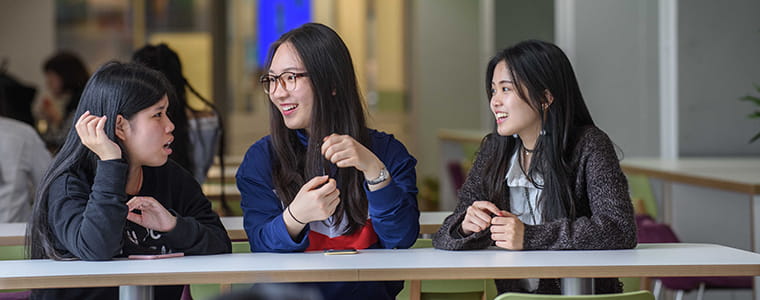 Three students talking to each other