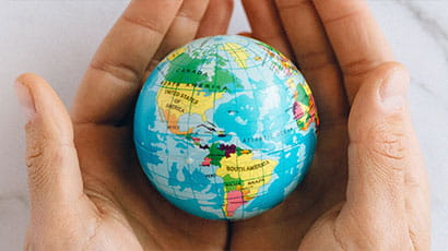 Human hands holding the globe 
