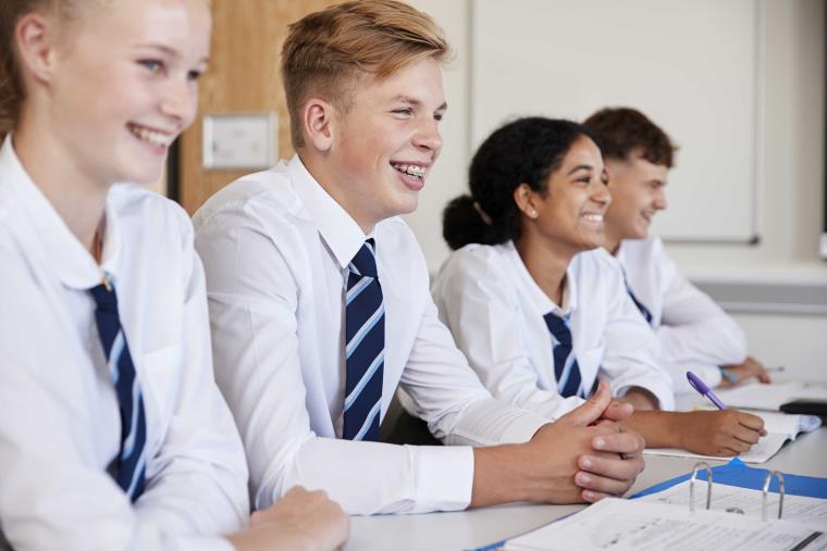 Four students studying and smiling brightly