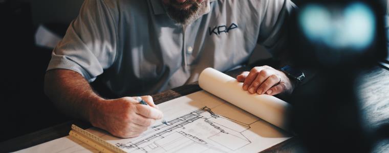An architect drawing his design on paper