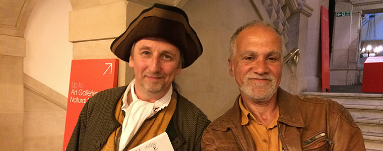 Two people posing inside a museum