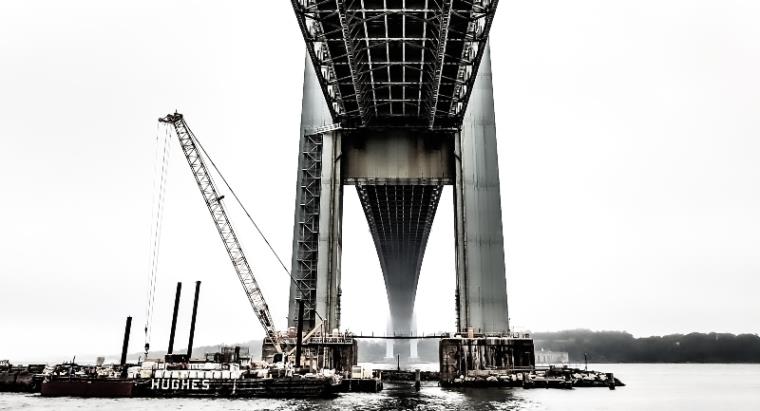 A black and white image of a bridge seen from below
