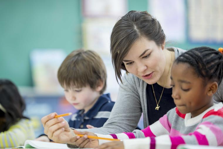 A teacher teaching kindergarten children in a classroom