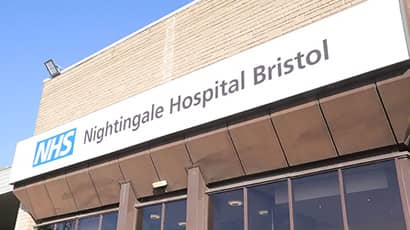 The outside of the University of the West of England conference centre, which has a large sign reading "NHS Nightingale Hospital Bristol".