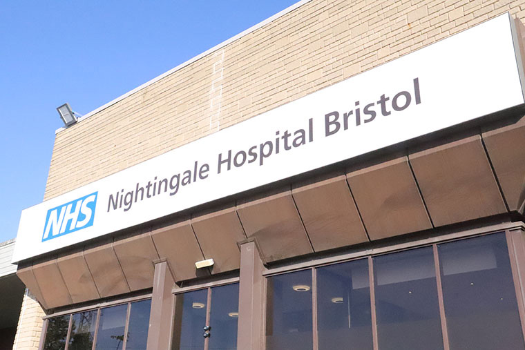 The outside of the University of the West of England conference centre, which has a large sign reading "NHS Nightingale Hospital Bristol".