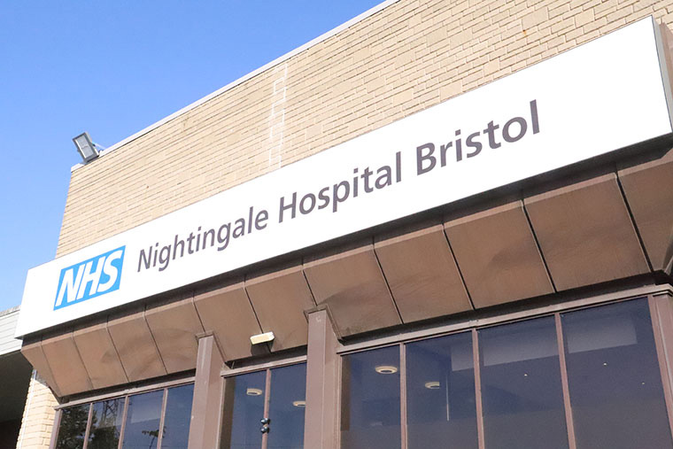 The outside of the University of the West of England conference centre, which has a large sign reading "NHS Nightingale Hospital Bristol".
