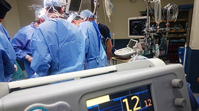 Doctors in a hospital operating theatre, carrying out surgery on a patient